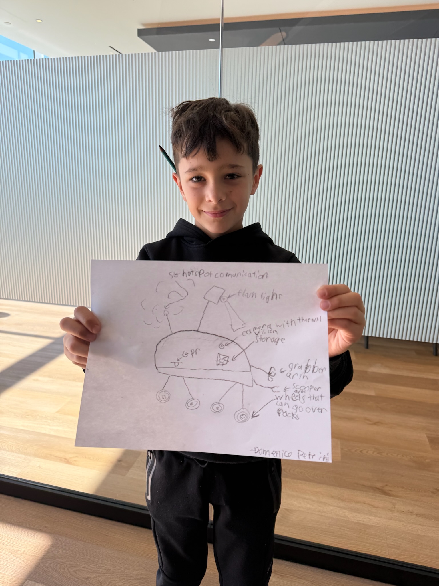 Tidal Engineers young teammate showing a drone idea drawing
